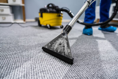 professional cleaner providing Commercial Carpet Cleaning in Littleton, CO